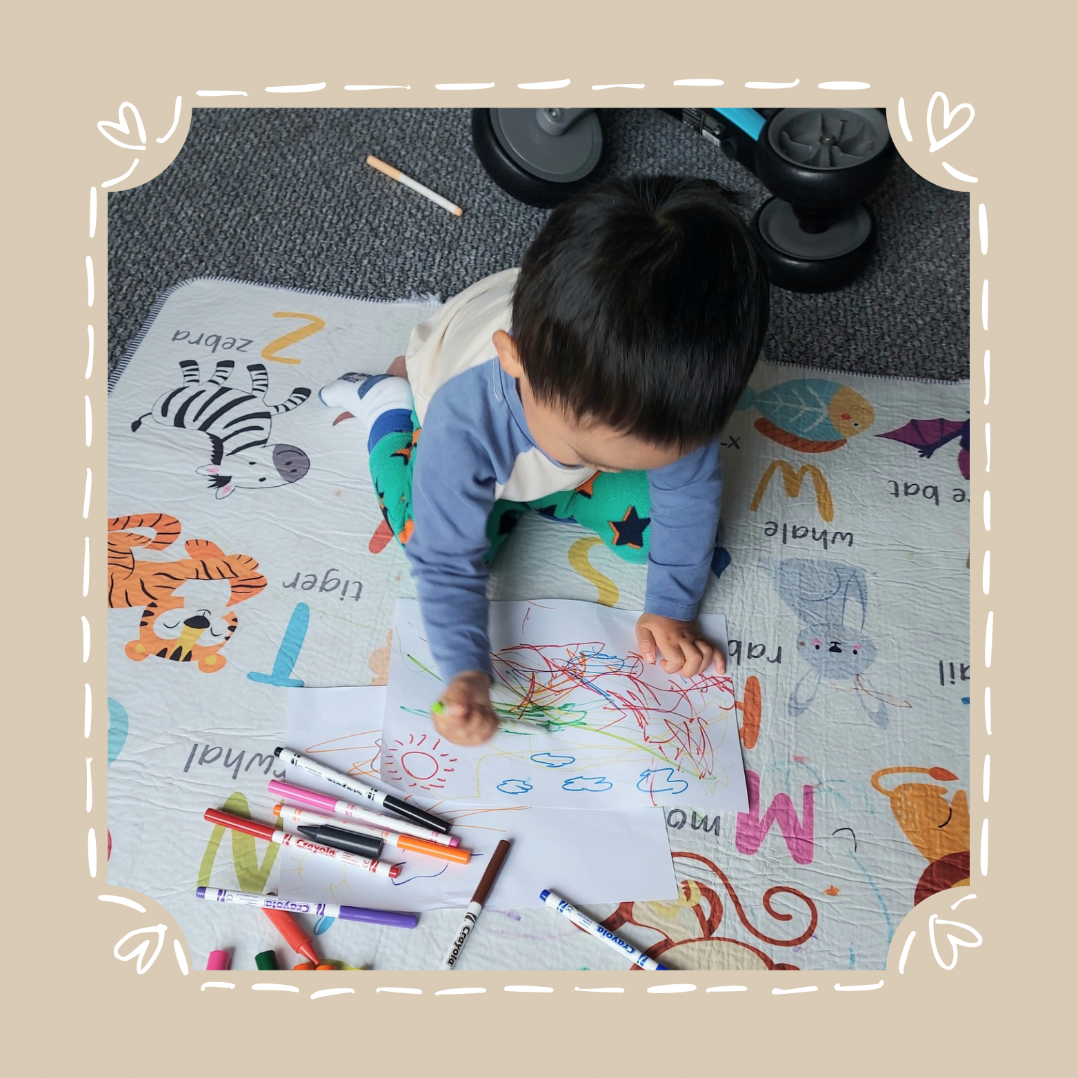 About section Toddler scribbling on paper, inspiration behind Scribble and Giggle